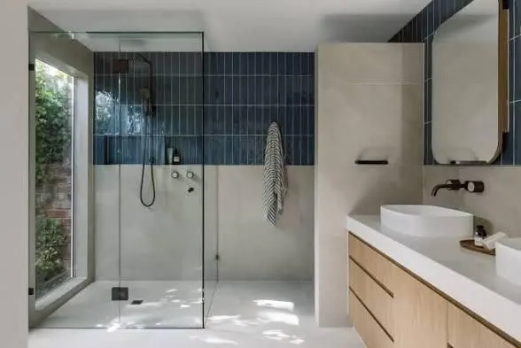 Bathroom with a walk in shower, blue vertical feature tiles, timber vanity and a garden window