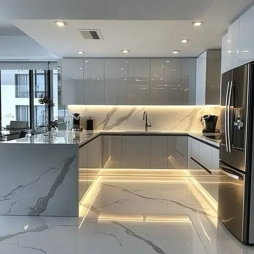 High gloss grey kitchen with a marble look waterfall island, LED kickboard lighting and a stone splashback