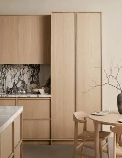 Timber veneer kitchen with floor to ceiling cabinetry and a bold natural marble splashback
