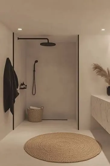 Neutral walk in shower with seamless rendered walls, black tapware and a frameless glass screen